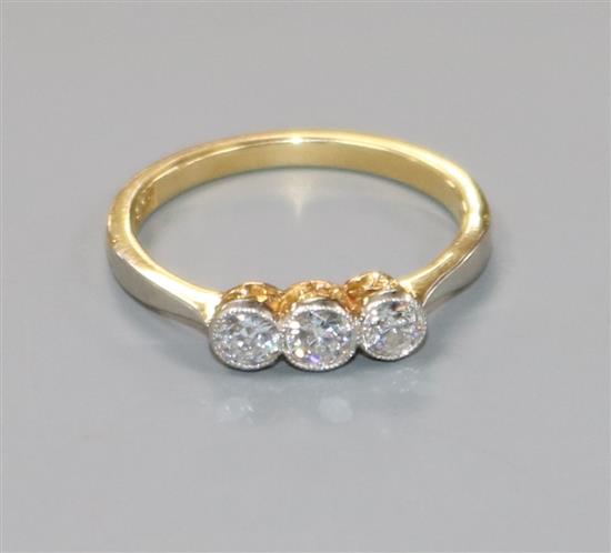 An 18ct gold and three stone diamond ring, size J.